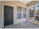 A private patio with screened windows and a gray entry door at 5011 Hemingway Cir # 5011, Haines City, FL 33844