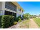 The exterior shows lush landscaping along the building with sidewalks leading to the entrances at 711 Springer Dr # 2, Lake Wales, FL 33853