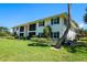 Condo building with lush landscaping surrounding the property at 711 Springer Dr # 2, Lake Wales, FL 33853
