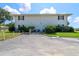 A view of the building's rear, including a parking lot and manicured grounds at 711 Springer Dr # 2, Lake Wales, FL 33853