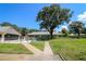 View of the fenced in pool area with a large tree providing shade at 711 Springer Dr # 2, Lake Wales, FL 33853