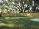 Expansive backyard with a wooden fence, green grass, and shady trees at 815 S Seminole Ave, Fort Meade, FL 33841