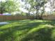 Large grassy backyard enclosed by a wood fence offering privacy and space at 815 S Seminole Ave, Fort Meade, FL 33841