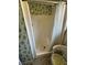 Shower featuring patterned wall, showerhead, a clear curtain and wicker chair at 1385 N Lake Reedy Blvd, Frostproof, FL 33843