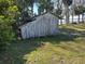 Side view of an exterior storage shed surrounded by trees and grass at 1385 N Lake Reedy Blvd, Frostproof, FL 33843