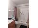 Features a walk-in shower with grab bars, vanity, toilet, and tile flooring at 1402 Thousand Roses Dr. W. # 1402, Lake Wales, FL 33853