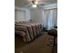 Spacious bedroom with carpeting, large windows, neutral color palette, and bar seating area at 1402 Thousand Roses Dr. W. # 1402, Lake Wales, FL 33853