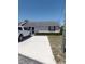 Single story home with white brick, red shutters, concrete driveway, and a white pickup truck at 1402 Thousand Roses Dr. W. # 1402, Lake Wales, FL 33853
