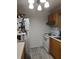 This kitchen offers white appliances, tiled floors, laminate counters, and wood cabinets at 1402 Thousand Roses Dr. W. # 1402, Lake Wales, FL 33853
