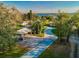 An aerial view showing the driveway, carport and surrounding mature trees at 1800 N Scenic Hwy, Babson Park, FL 33827