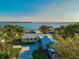 Aerial view showing the home, lush landscaping, and a view of the lake in the background at 1800 N Scenic Hwy, Babson Park, FL 33827