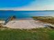 Overhead shot showcasing a lakefront property with a sandy beach and private pier at 1800 N Scenic Hwy, Babson Park, FL 33827