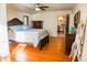 The main bedroom features hardwood floors, a ceiling fan, and access to the en-suite bathroom at 1800 N Scenic Hwy, Babson Park, FL 33827