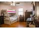 Cozy bedroom with a bunk bed, dresser, and hardwood floors creates a functional and inviting atmosphere at 1800 N Scenic Hwy, Babson Park, FL 33827