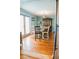 Bright dining room features wood floors, farmhouse table, and natural light from the glass paneled doors at 1800 N Scenic Hwy, Babson Park, FL 33827