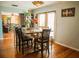 Cozy dining room features a long wood table, modern lighting, and access to the living room at 1800 N Scenic Hwy, Babson Park, FL 33827