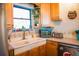 Kitchen featuring stainless steel appliances and a double basin sink at 1800 N Scenic Hwy, Babson Park, FL 33827