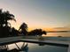 Poolside view with palm trees and a sunset sky over the lake at 1800 N Scenic Hwy, Babson Park, FL 33827