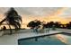 Pool and deck with seating and panoramic sunset views over the lake at 1800 N Scenic Hwy, Babson Park, FL 33827