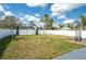 Large, grassy backyard featuring a privacy fence, offering plenty of space for outdoor activities and entertaining at 1831 Richmond Rd, Lakeland, FL 33803