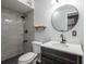 Modern bathroom featuring a tiled shower, modern vanity with sink, and a round mirror at 1831 Richmond Rd, Lakeland, FL 33803