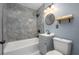 Modern bathroom features stylish tile work, bathtub with shower, and vanity sink at 1831 Richmond Rd, Lakeland, FL 33803