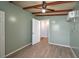 This bedroom offers wood-look vinyl flooring, ceiling fan, and wall air conditioning unit at 1831 Richmond Rd, Lakeland, FL 33803