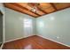 Cozy bedroom featuring a ceiling fan, wood floors, and natural light from the window at 1831 Richmond Rd, Lakeland, FL 33803