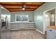 Dining area features wood look flooring, large window, built-in shelves, and stylish décor at 1831 Richmond Rd, Lakeland, FL 33803