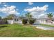 Charming single story home with well-maintained lawn, decorative shrubbery and gray driveway at 1831 Richmond Rd, Lakeland, FL 33803