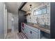 Kitchenette featuring gray cabinets, a black countertop, and stainless steel sink at 1831 Richmond Rd, Lakeland, FL 33803