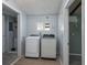 Laundry room features a washer, dryer, window, and access to an adjacent room at 1831 Richmond Rd, Lakeland, FL 33803