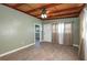 Living room features wood look flooring, ceiling fan, and large door and window openings at 1831 Richmond Rd, Lakeland, FL 33803