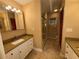 Bathroom featuring granite countertops, white cabinetry, and a walk-in shower at 1893 N Lake Reedy Blvd, Frostproof, FL 33843