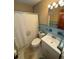 Comfortable bathroom featuring a tub with shower curtain, toilet, and vanity sink at 1893 N Lake Reedy Blvd, Frostproof, FL 33843