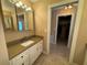 Bathroom featuring granite countertops, white cabinetry, and tile floors at 1893 N Lake Reedy Blvd, Frostproof, FL 33843