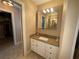 Bathroom with granite countertops, white cabinetry, and a view of the closet at 1893 N Lake Reedy Blvd, Frostproof, FL 33843