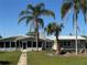 The exterior of this home offers a lush yard with mature palm trees and a welcoming facade at 1893 N Lake Reedy Blvd, Frostproof, FL 33843