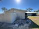 View of the property, showing the home's exterior, fence, and surrounding yard with blue sky at 1893 N Lake Reedy Blvd, Frostproof, FL 33843