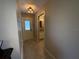 Hallway view with tile flooring leading to the bathroom and the back door at 1893 N Lake Reedy Blvd, Frostproof, FL 33843