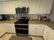 Well-equipped kitchen featuring stainless steel appliances and white cabinets at 1893 N Lake Reedy Blvd, Frostproof, FL 33843