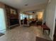 Open living room featuring a stone fireplace, tile floors, and neutral color palette at 1893 N Lake Reedy Blvd, Frostproof, FL 33843