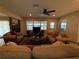 Comfortable living room featuring a fireplace, a ceiling fan, and neutral tones at 1893 N Lake Reedy Blvd, Frostproof, FL 33843