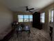 Cozy living room with water views featuring a decorative rug and a ceiling fan at 1893 N Lake Reedy Blvd, Frostproof, FL 33843