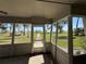 Screened-in porch with view of the water, showing a walkway leading to a dock at 1893 N Lake Reedy Blvd, Frostproof, FL 33843