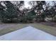 Expansive backyard with mature trees provides a private and serene outdoor space at 2134 R E Byrd Rd, Frostproof, FL 33843