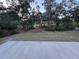 View of the wooded backyard from a concrete patio at 2134 R E Byrd Rd, Frostproof, FL 33843