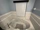 Relaxing bathroom featuring a large soaking tub with grey tile at 2134 R E Byrd Rd, Frostproof, FL 33843