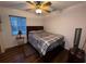 Comfortable bedroom with a ceiling fan, a double bed, and a side table at 2134 R E Byrd Rd, Frostproof, FL 33843