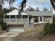 Charming home with stone accents, screened porch, and an attached garage at 2134 R E Byrd Rd, Frostproof, FL 33843